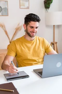 Happy man using a tablet to editing photographies Stock Photos