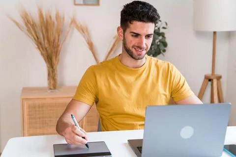 Happy man using a tablet to editing photographies Stock Photos