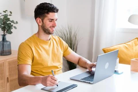 Happy man using a tablet to editing photographies Stock Photos