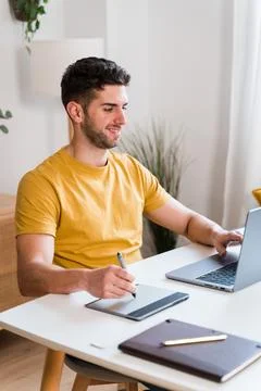 Happy man using a tablet to editing photographies Stock Photos