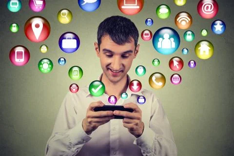 Happy man using texting on smartphone social media application icons flying u Foto stock