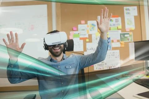 Happy man in VR headset looking to green lights interfaces 스톡 사진