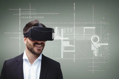 Happy man in VR headset looking at interface against green background with 스톡 사진