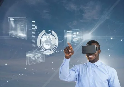 Happy man in VR headset touching interface against blue sky with flares 스톡 사진