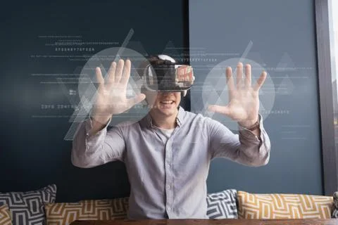 Happy man in VR headset touching interfaces with flares Stockfoto's