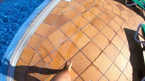 Happy man walking by the pool in slow motion Stock Footage 88645621