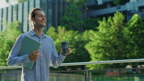 Happy Man Walking From Work, Holding a Laptop and Cup of Coffee. Video stock 312731403