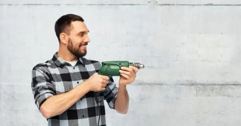 Happy man, worker or builder with drill Stock Photos