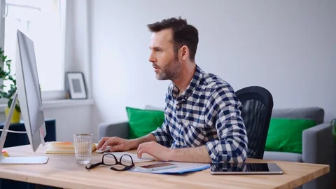 Happy man working from home using computer Stock Footage 126831747