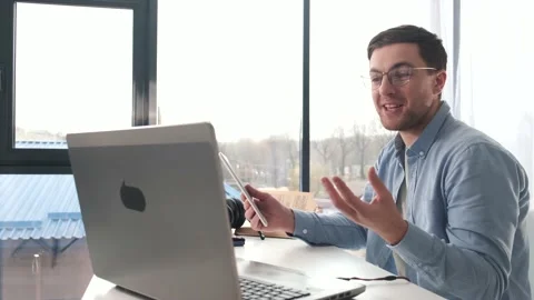 Happy man working from home using digital tablet and laptop Stock Footage 145763616