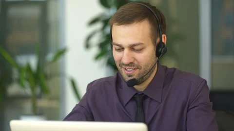 Happy man working as an operator in the center of the number Stock Footage 67661865