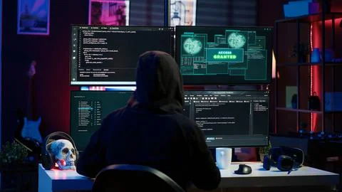 Happy man writing code on PC, celebrating after managing to get past security Stock Photos