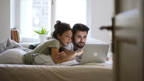 Happy married caucasian couple using laptop at home Spbd. man and woman watching Stock-Footage 128285445