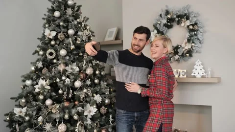 Happy Married couple using mobile phone talking waving to family Happy New Year. Stock Footage 142662415