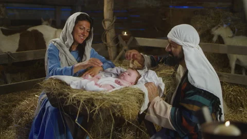 Happy Mary and Joseph with baby Jesus near stalls Stock Footage