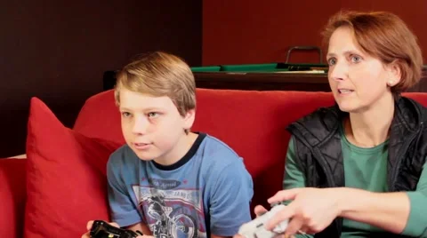 Happy maternity - a cute boy playing video games  with his mother Stock Footage 47682552