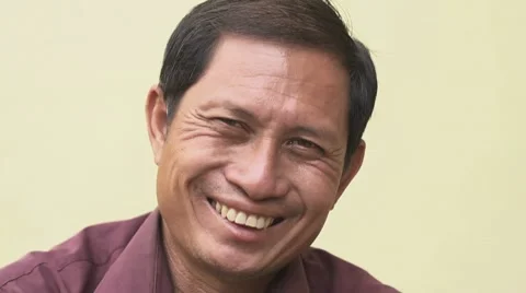 Happy mature Asian man smiling and looking at camera Stock Footage
