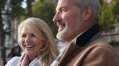 Happy mature couple talking whilst outside Stock Footage