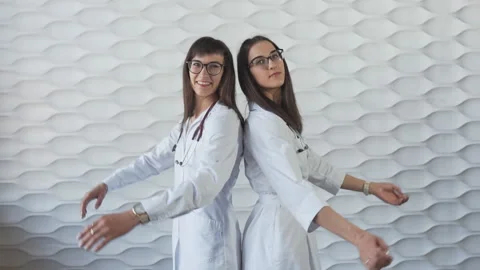 Happy medic workers. Portrait of two doctors in white coats and glasses at white Stock Footage 114078173