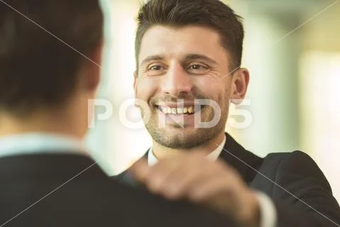 The happy men hold on the shoulder in the office Stock Photos