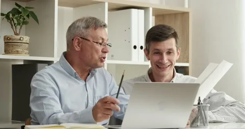 Happy men talking checking bills and laptop computer, satisfied bank clients Stock Footage 156835965