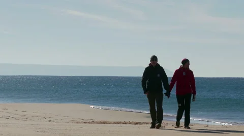 Happy Middle-aged Couple Walking on Beach Stock Footage 45577694