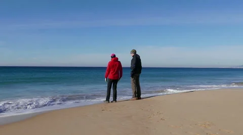Happy Middle-aged Couple Walking on Beach Stock Footage 45577975