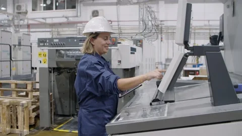 Happy middle aged factory engineer testing industrial machine Stock Footage 147500067