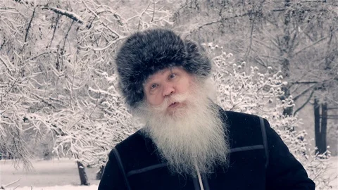 Happy middle aged man dancing and whistling a song at snow-covered urban park 動画素材 123343253