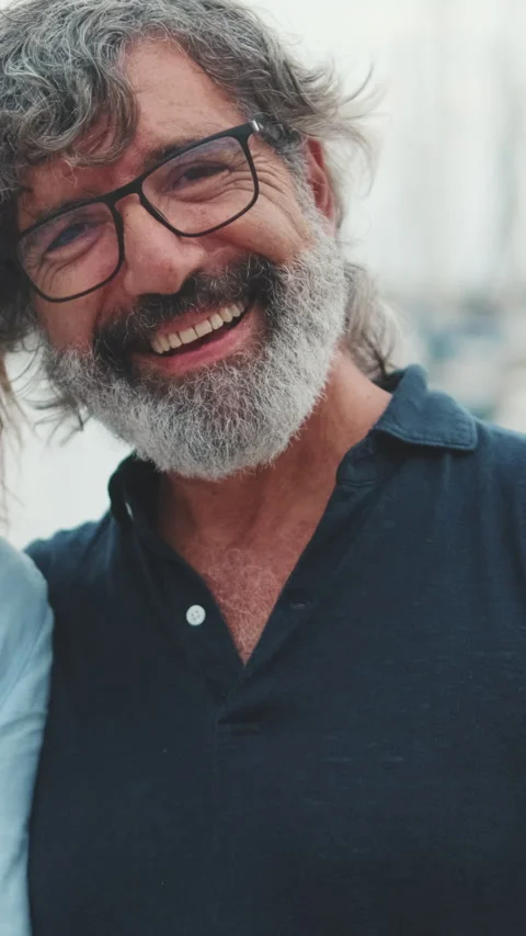 Happy middle aged man standing in the port on the yacht background looking at Stock Footage 252031205