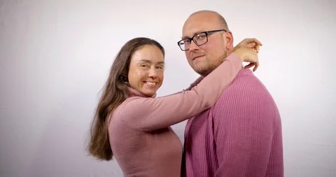 Happy middle aged spouses are hugging in room, woman is snuggling to her husband Stock Footage 116764474