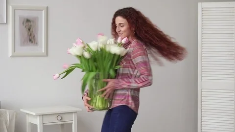 Happy middle eastern girl dancing with a spring bouquet of flowers Stock Footage 87100196