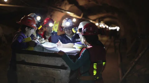 Happy miners discussing planes of work Stock Footage 34472953
