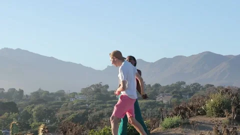 Happy Mixed Race Couple Dancing Around, Holding Hands, Amazing View At Sunset  Stock Footage 201821316