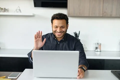 Happy mixed-race guy using laptop for video connection Stock Photos