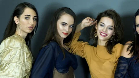 Happy models with classy makeup in luxurious earrings are smiling  at studio Stock Footage 93542609