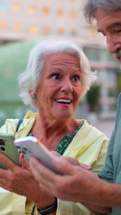 Happy modern senior couple using smartphone in the city Stock Footage 291620114