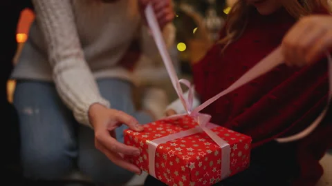 Happy mom and dad present a surprising Christmas gift to their little daughter Video stock 294900031