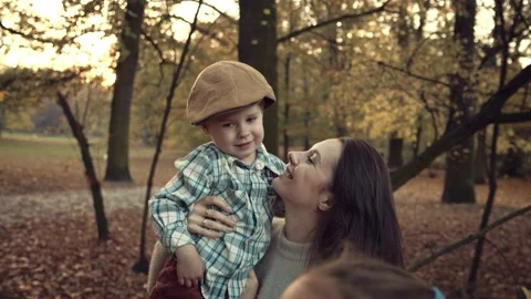 Happy mom with her son having fun in autumn leaves Stock Footage 131886862