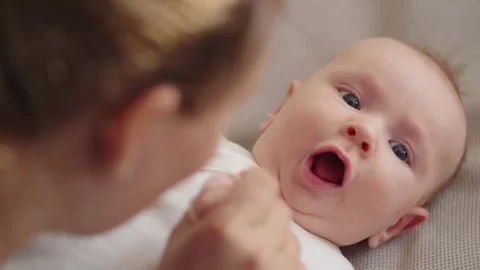 Happy mom spends time with her baby. Mother playing and kissing with a newb.. Stock Footage 254652225