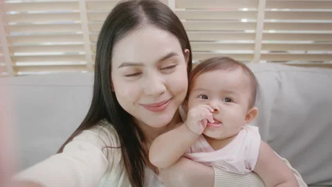 Happy mother and baby girl looking at Stock Video Pond5