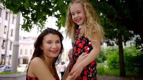 Happy mother and daughter playing with your palms and show each other the Stock Footage