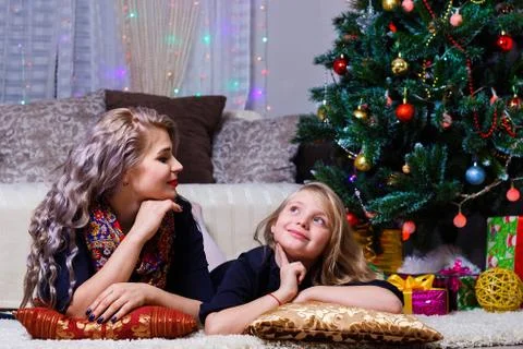 Happy mother and daughter, posing against the Christmas tree, Christmas and n Stock Photos