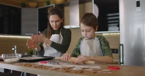 Happy mother and son cooking cookies together in the kitchen. Family day Stock Footage 170326341