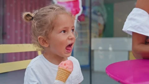 Happy mother and son eating ice cream. Close-up of a little boy and a young Stock Footage 261978853
