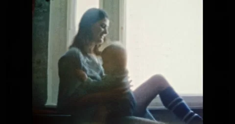 Happy mother having fun with laughing child in room. Cheerful young woman Stock Footage 197673786