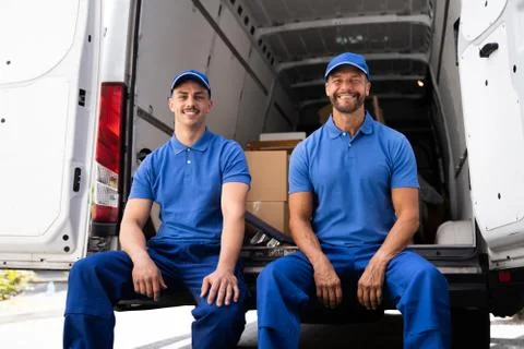 Happy Movers With Van Or Truck. Furniture Removal Stock Photos