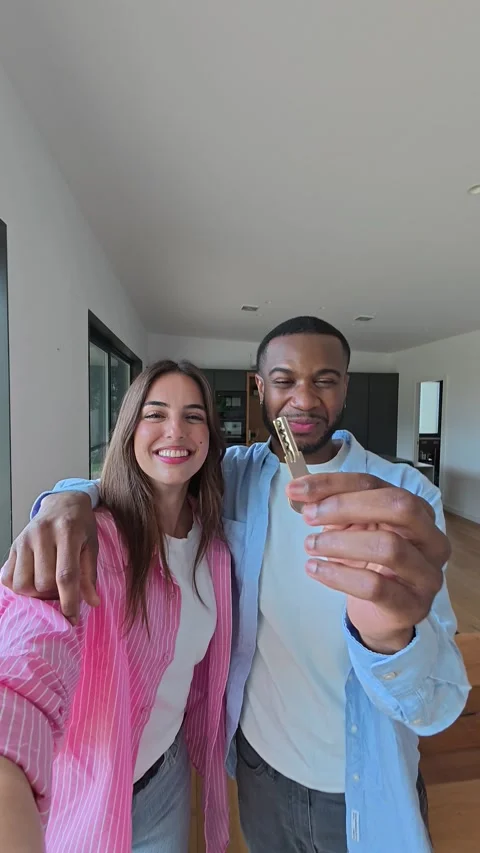 Happy Multi-ethnic Couple Joyfully Holds Up Keys to Their New Modern Home Vídeos de archivo 333542585