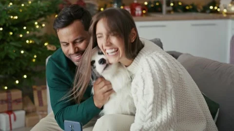 Happy multi ethnicity couple taking selfie with dog during the Christmas Stock-Footage 218746256