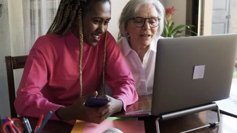 Happy multi generational senior and young women doing video call at home during 스톡 동영상 165600274
